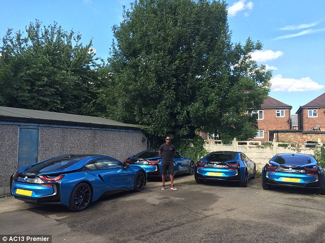 Marlon Harewood đứng trước dàn siêu xe BMW i8 của các cầu thủ Leicester City.