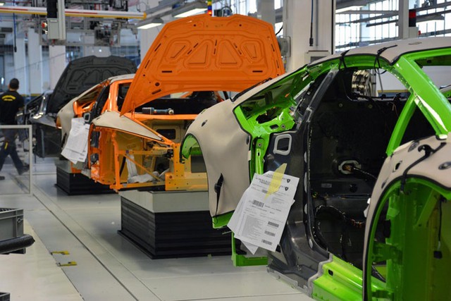 Thân vỏ những chiếc Lamborghini Huracan được phủ lớp vỏ bảo vệ. Trên xe còn gắn tờ thông số kỹ thuật. Hình ảnh này cho thấy sự kết hợp giữa hai chất liệu nhôm và sợi carbon để giảm trọng lượng của Lamborghini Huracan.