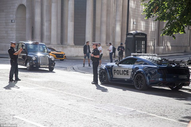 
Hai cảnh sát chụp ảnh với Ford Mustang
