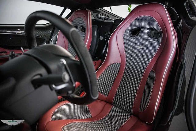 
Trái với bộ áo trắng tinh tế ở ngoại thất, siêu xe One-77 này có bộ ghế ngồi màu đỏ kết hợp cùng các sọc caro màu đen khá lạ mắt.
