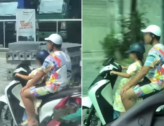 Người đàn ông ngồi sau để bé gái điều khiển xe máy chạy băng băng trên đường - Ảnh 1.
