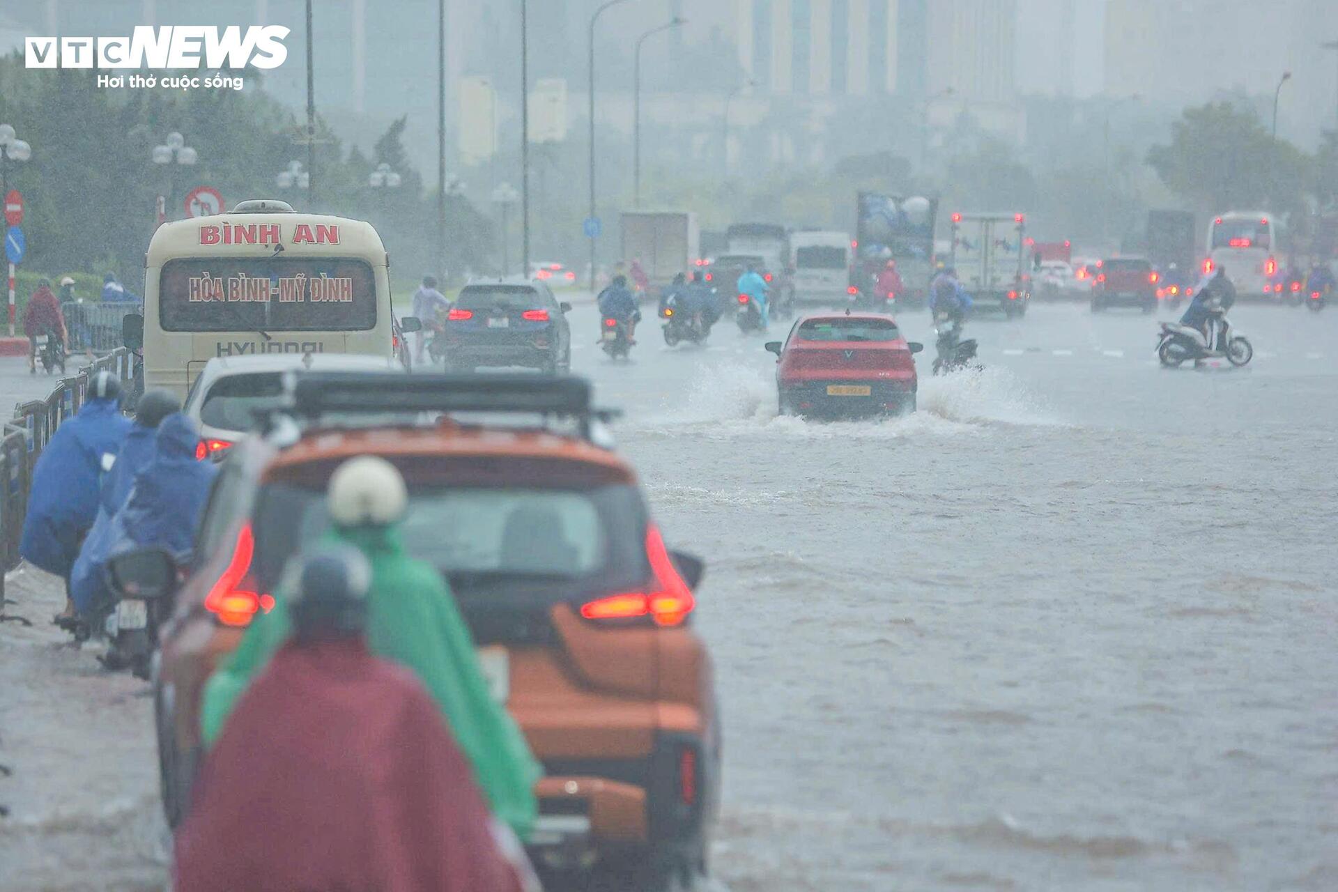 Loạt tuyến phố Hà Nội ngập nặng, người dân bì bõm dắt xe dưới mưa lớn- Ảnh 4.