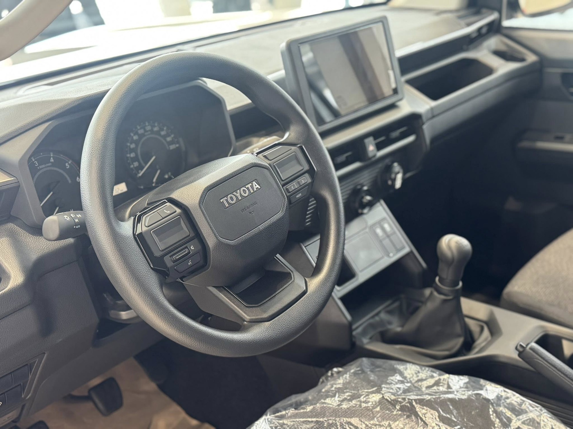 Ảnh thực tế Toyota Hilux 2026 bản rẻ nhất vừa ra mắt Việt Nam: M&acirc;m sắt, v&ocirc;-lăng nhựa, số s&agrave;n nhưng trang bị giải tr&iacute;, động cơ vẫn &lsquo;ngon&rsquo;- Ảnh 8.