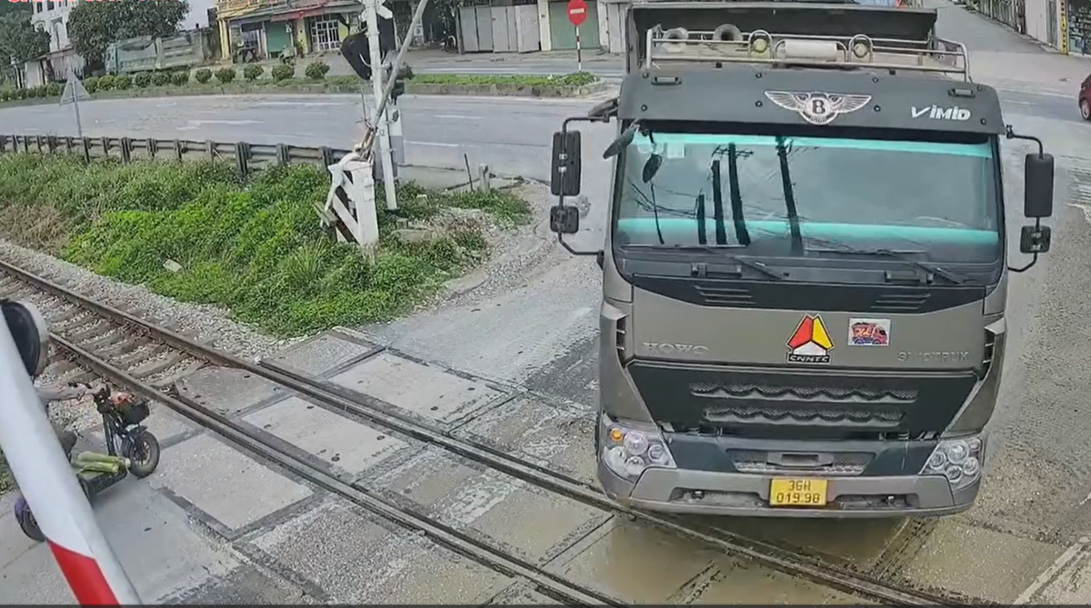 VIDEO: Th&oacute;t tim cảnh xe tải t&ocirc;ng g&aacute;c chắn, cố vượt qua đường sắt ngay trước "mũi" t&agrave;u hỏa- Ảnh 1.