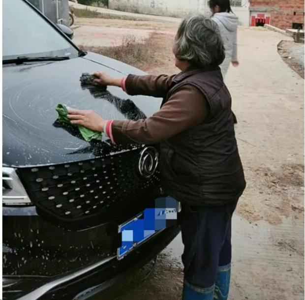 Seeing his mother-in-law enthusiastically wash the newly bought car for him, the son-in-law got closer to his soul with what she held in her hand, the result made him cry - Photo 1.