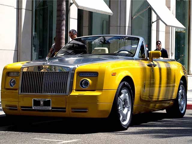 
Đây là một chiếc Rolls-Royce Phantom bản mui trần được phối màu vàng tươi xuất hiện trên phố Rodeo Drive ở Los Angeles (Mỹ). Chiếc xe này được sản xuất với mục đích phục vụ phim Great Gatsby khi đi liền với nhân vật tay buôn lậu rượu huyền thoại từ năm 1920. Song dẫu vậy, đây cũng là một gợi ý hay cho các đại gia sở hữu Rolls-Royce nếu muốn làm chiếc xe của mình trở nên tươi mới.
