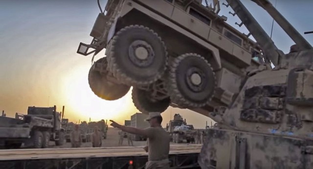 Chiếc MRAP bị hỏng được đưa lên thùng sau của xe đầu kéo sàn phẳng hạng nặng.