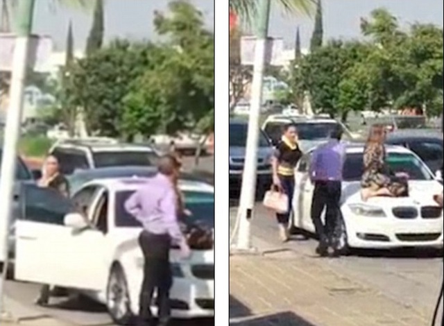 
Người vợ ngồi trên nắp capô xe BMW trong khi cô nàng nhân tình bước ra ngoài.
