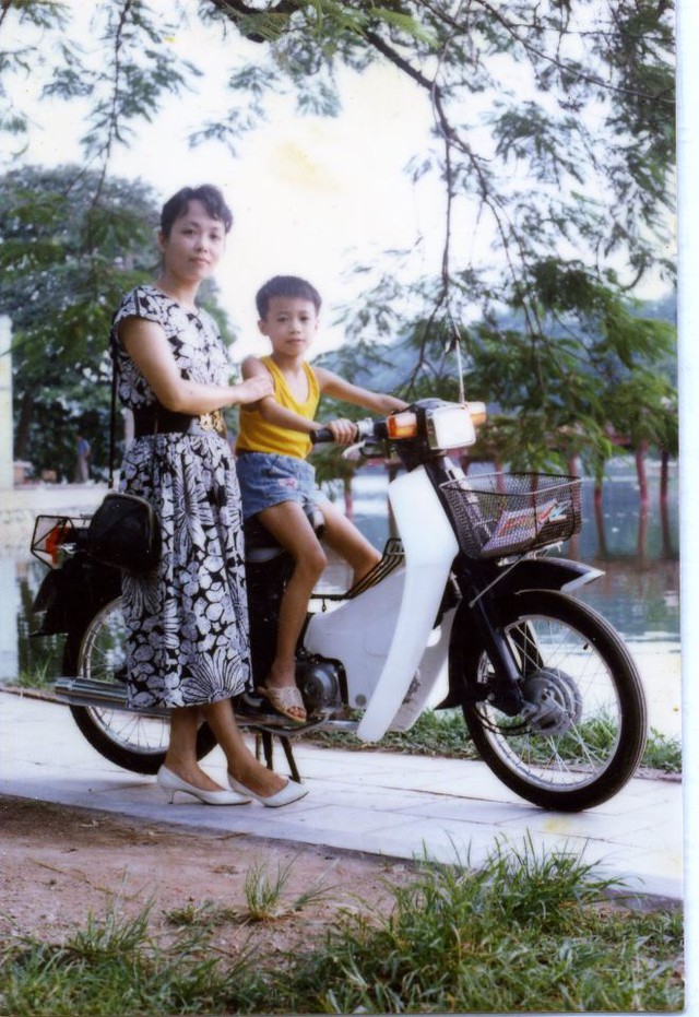 
Bé trai Hà thành tạo dáng cùng mẹ bên chiếc Honda Cub 70 tại bờ hồ Hoàn Kiếm.
