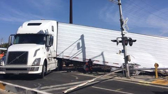 Nhảy khỏi buồng lái xe container mắc kẹt trên đường ray, một tài xế thoát chết