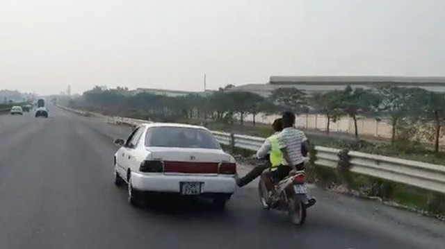 Bàn chân vàng trong làng cứu hộ: Nam thanh niên đi xe máy dùng chân không đẩy ô tô chạy băng băng trên cao tốc