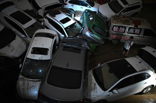 Xót xa hình ảnh hàng trăm ô tô chất đống lên nhau do lũ lụt: Nhiều chiếc là xe sang đắt tiền - Ảnh 1.