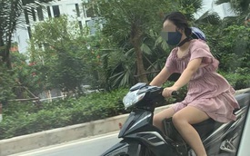 Cô gái chạy xe máy có phong cách đội mũ bảo hiểm khiến cả phố ngoái nhìn